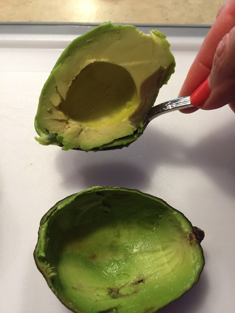 remove avocado flesh with a spoon