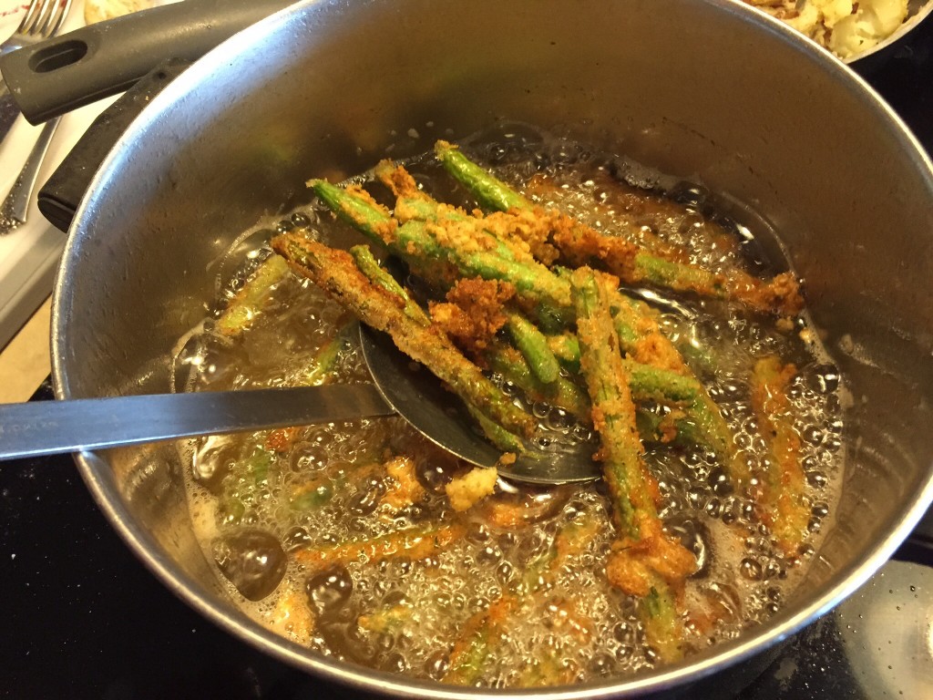 Strain the french fried green beans.