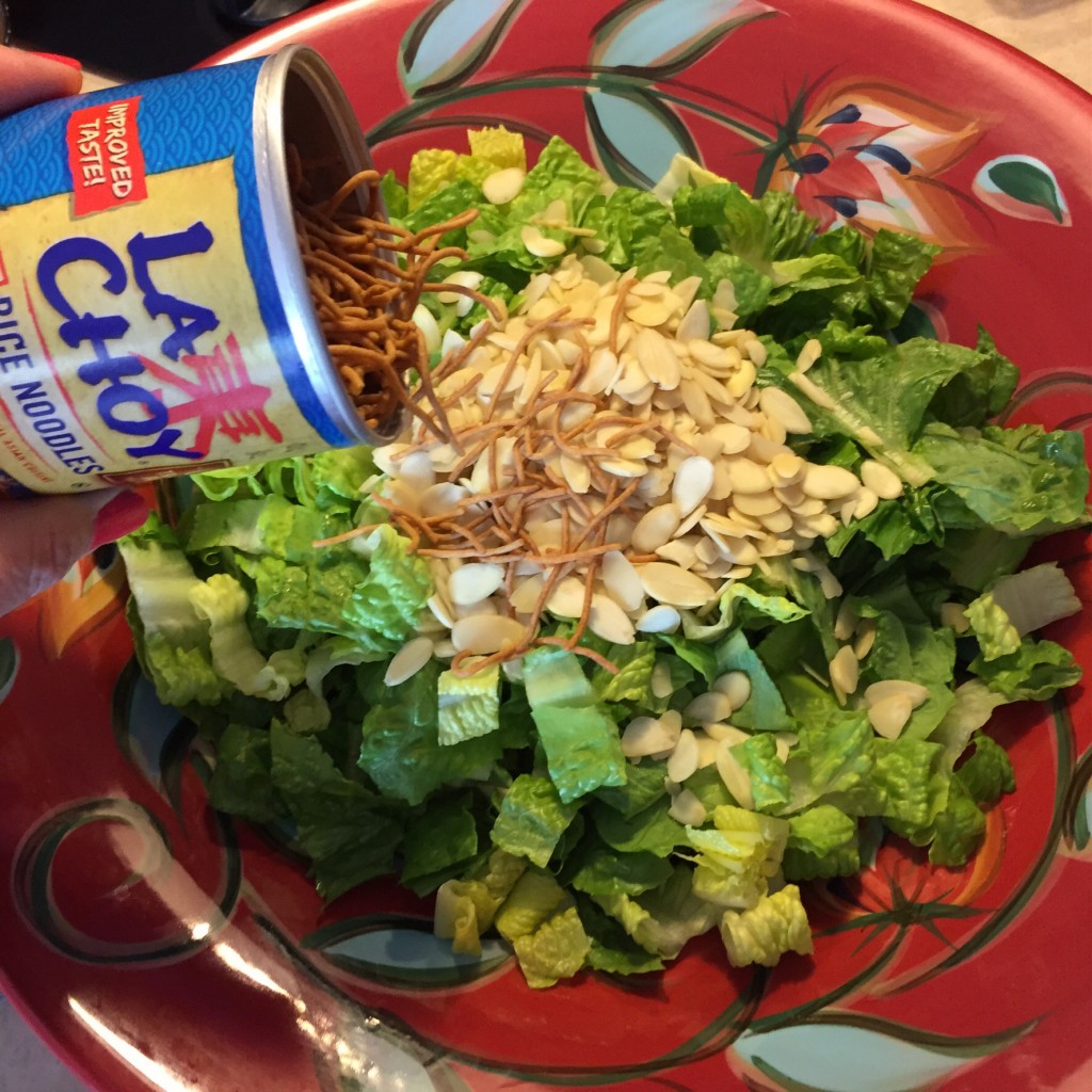 Add almonds and rice noodles to the salad.