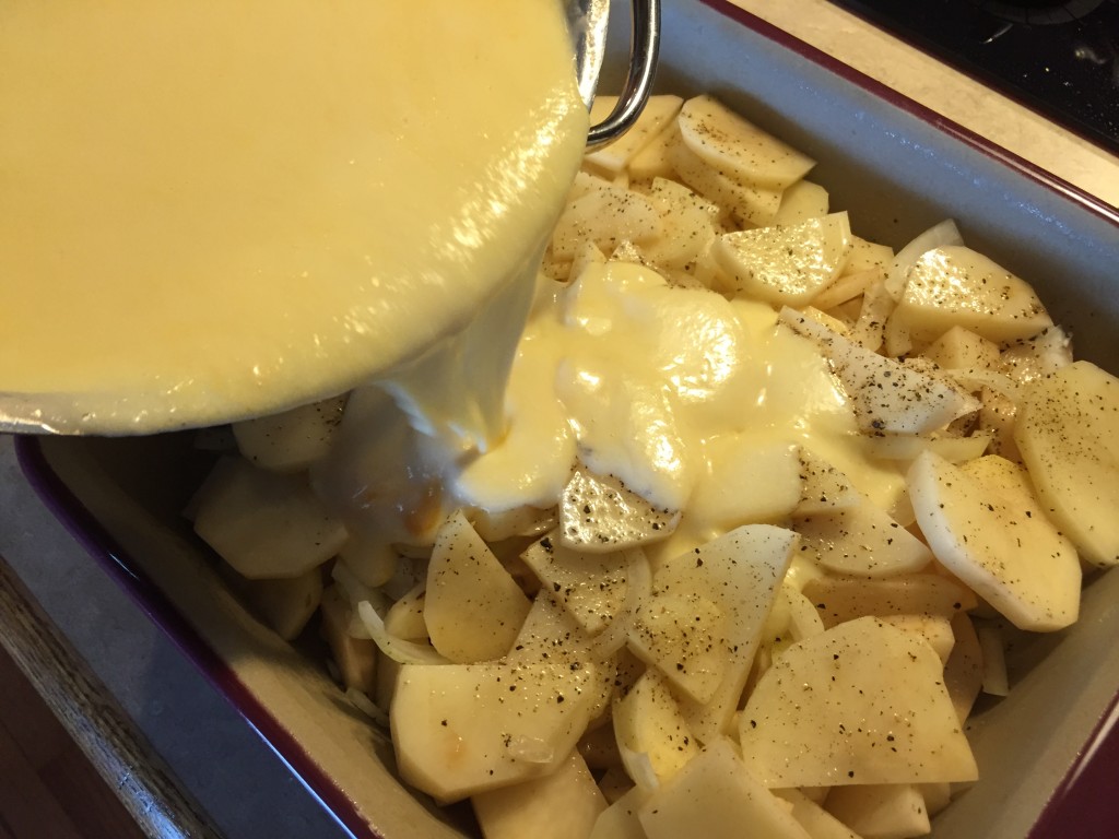 pour the cheese sauce over the potatoes