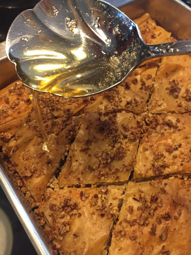 Spoon the warm sugar over the baklava.