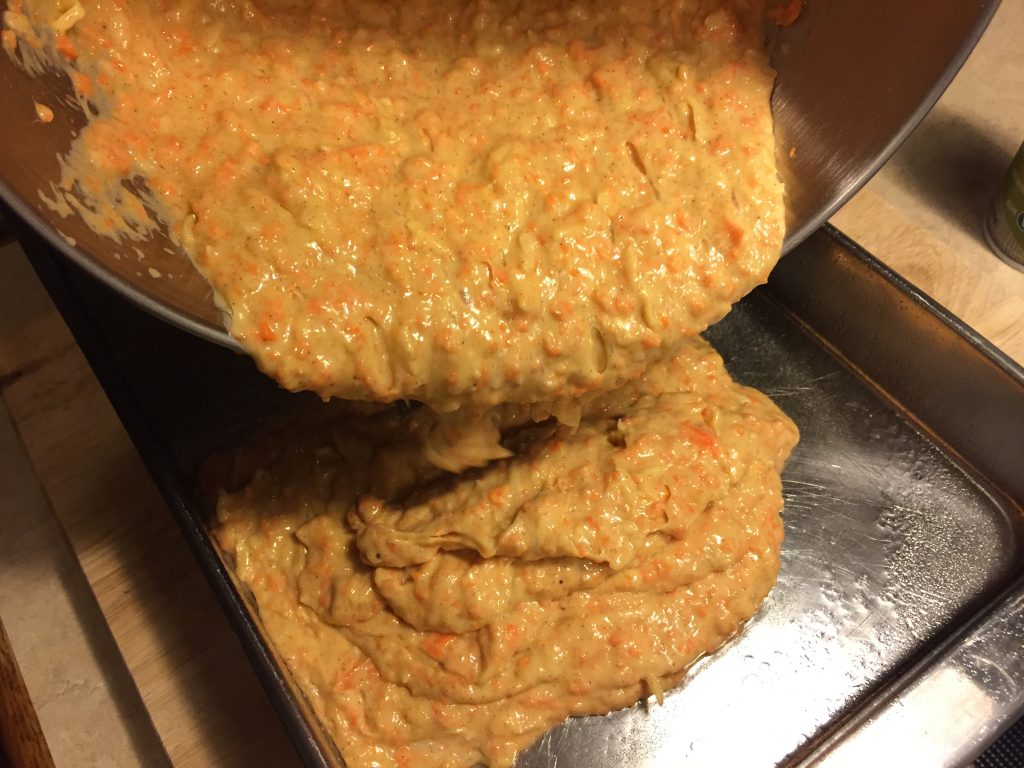 Pour carrot cake into the prepared pan.