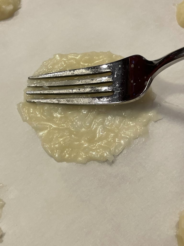 Flatten the coconut mixture on the sheet pan.