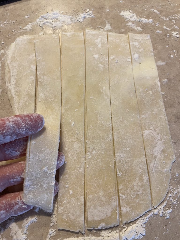 Cut strips of dough for Lady Locks.