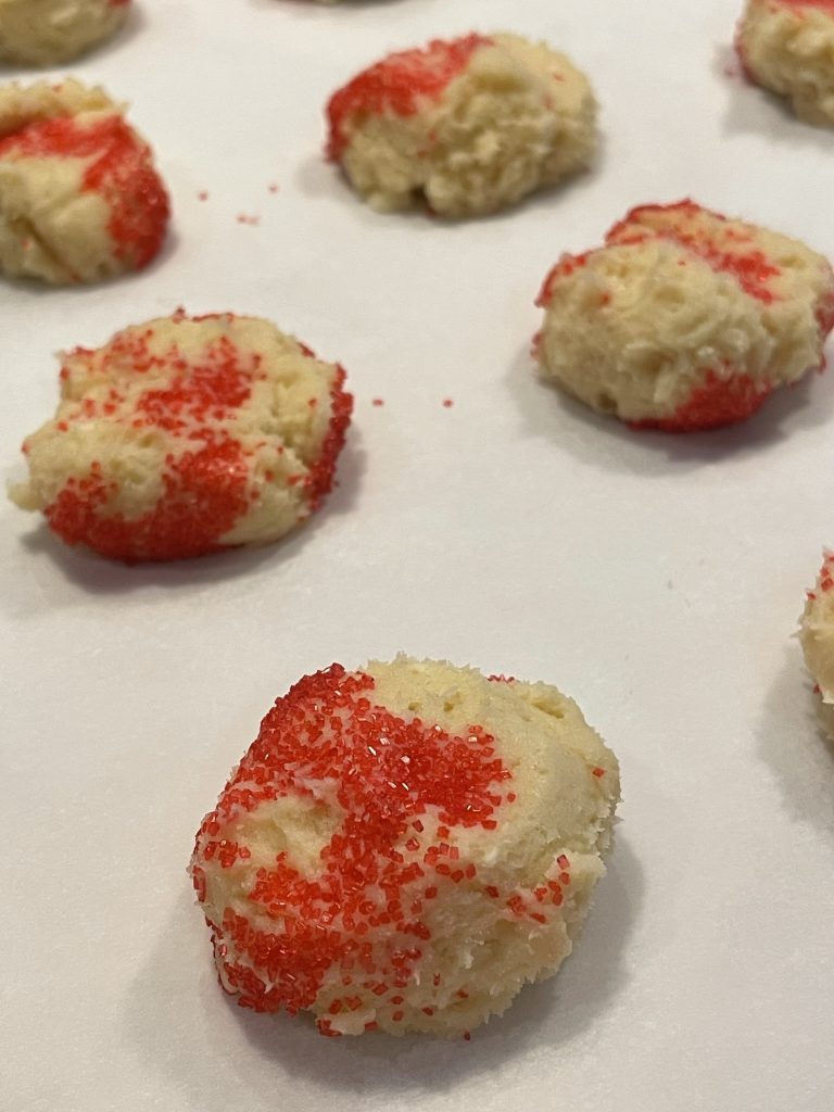 roll cookies in red sugar