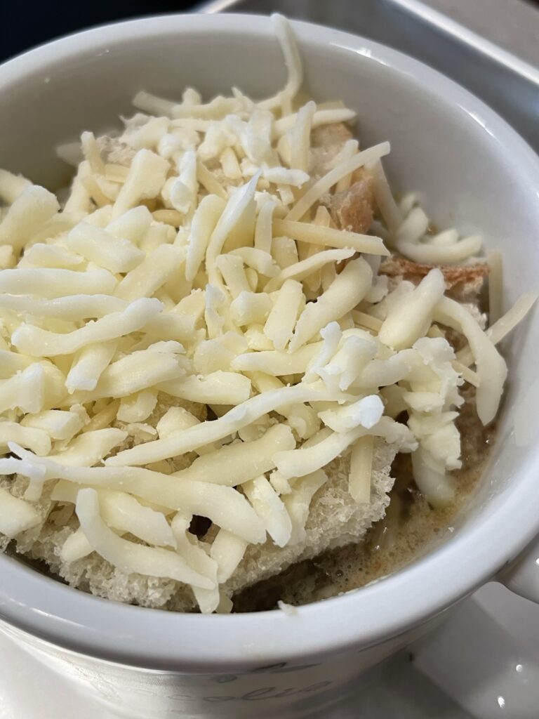 Shredded cheese on French Onion Soup