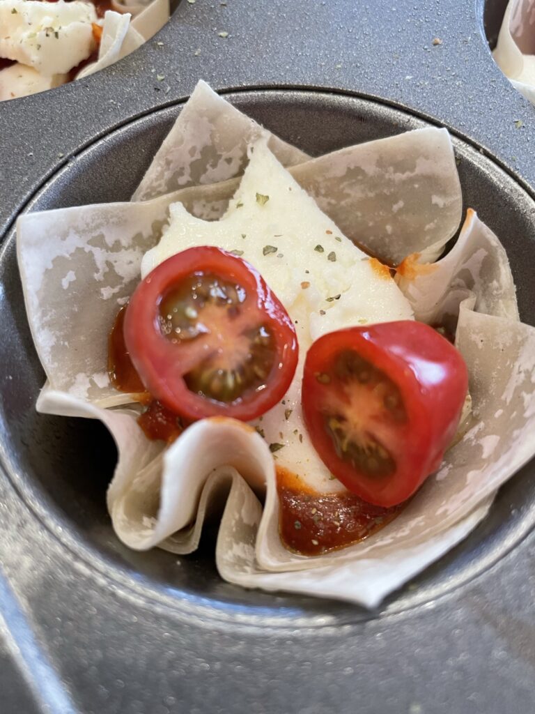 Using wonton wrappers to make Margherita Pizza Cups.