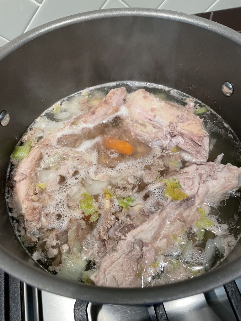 Simmering turkey and vegetables to make turkey stock.